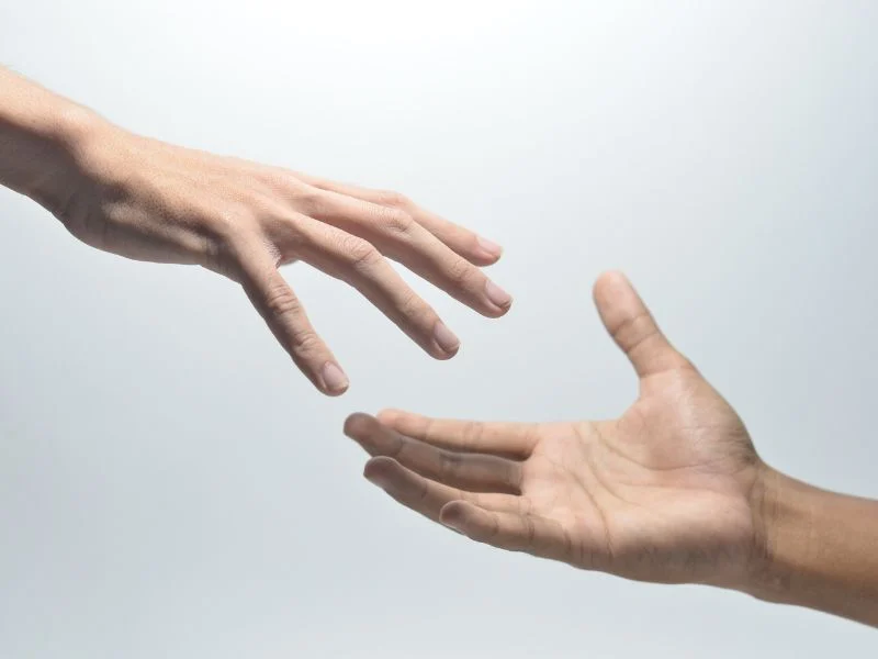 hands reaching out to one another