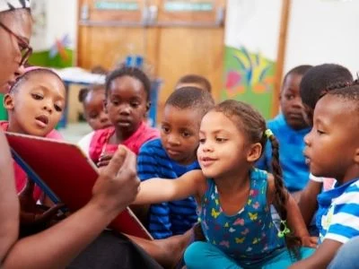 teacher teaching a group of children